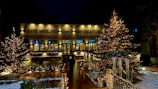 The café storefront at dusk, warmly lit with a welcoming glow and inviting entrance.