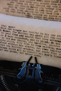 Close-up of a vintage typewriter with dark charcoal ink on bone-colored paper