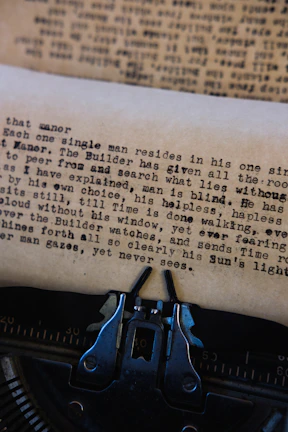Close-up of a vintage typewriter with a half-typed mysterious letter on black paper.