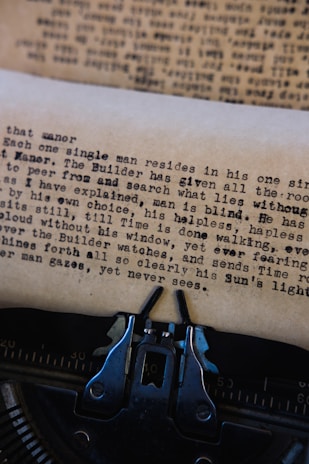 A close-up of a vintage typewriter with scattered pages.