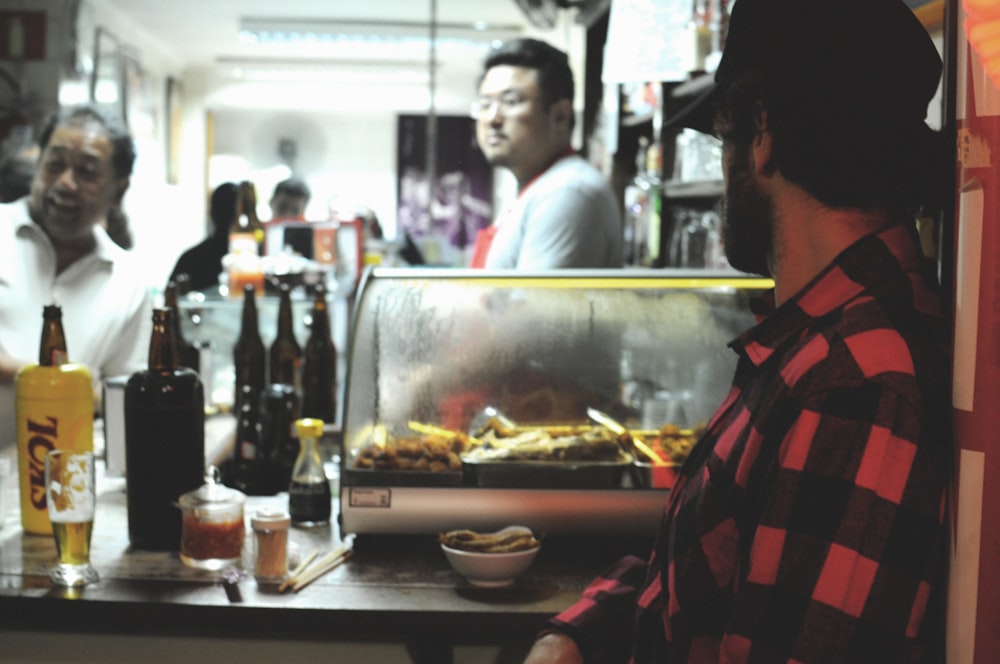 man facing food stall