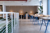 white-and-blue tables facing white balustrade