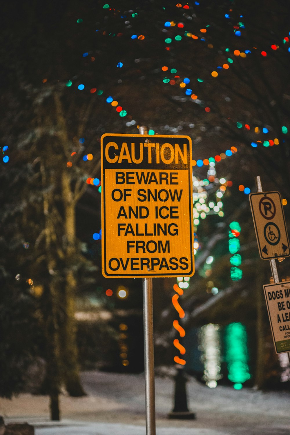 caution beware of snow and ice falling from overpass sign