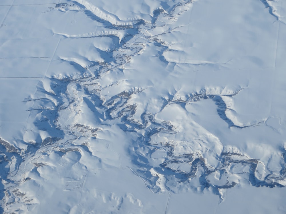 an aerial view of a snow covered mountain range