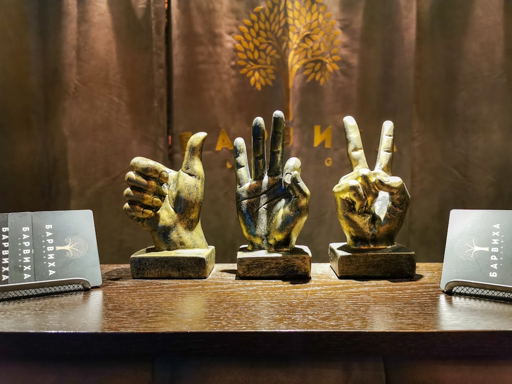 three gold hand sign decors