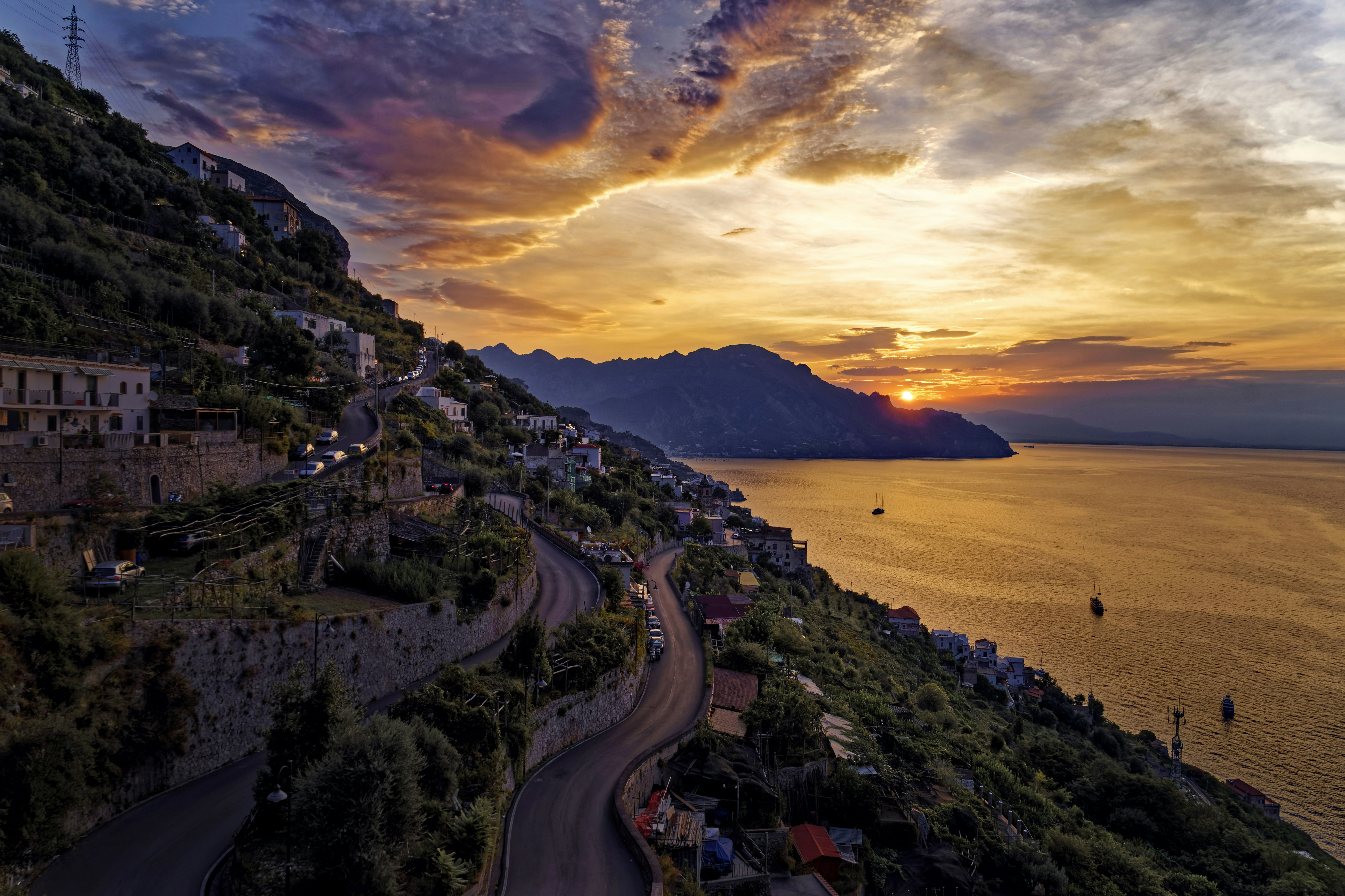 Buildings on cliff near body of water
