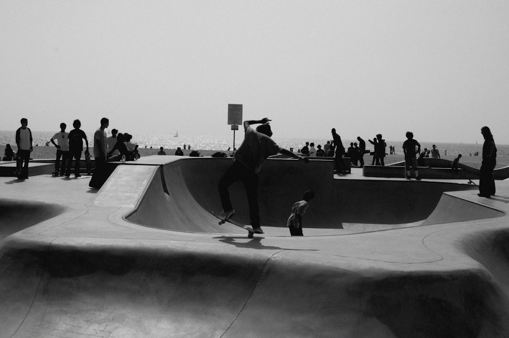 greyscale of people playing skateboard