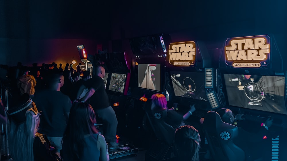 people inside building with Star Wars arcade machine