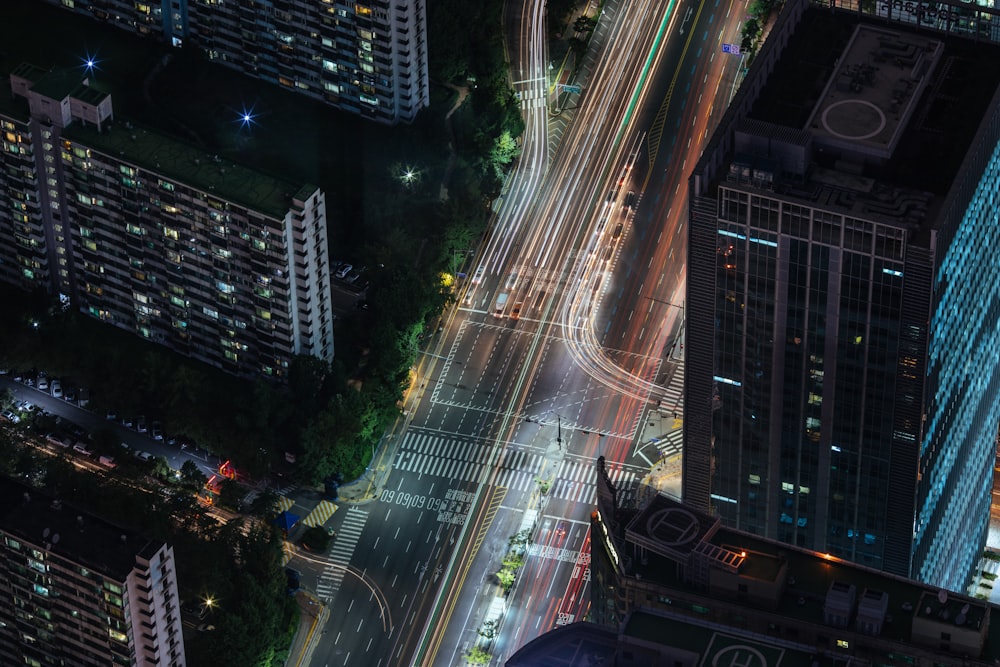 aerial photography of road between buildings at night