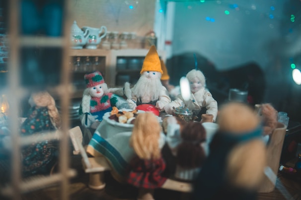 A playful scene with dolls dressed in pukydoll outfits, posed in a cozy room setting.