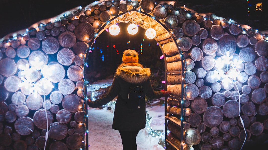 woman standing under arch with lights