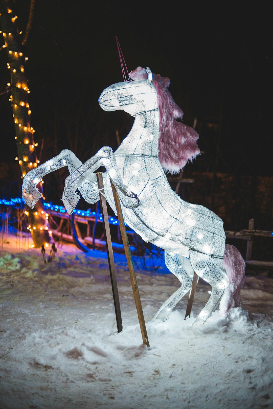 white rearing horse Christmas decor during night time