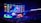 A large esports arena featuring a massive screen displaying a video game, surrounded by sponsor logos and team names. The auditorium is filled with spectators watching the gaming event. Neon blue and purple lights illuminate the stage, creating a vibrant atmosphere.