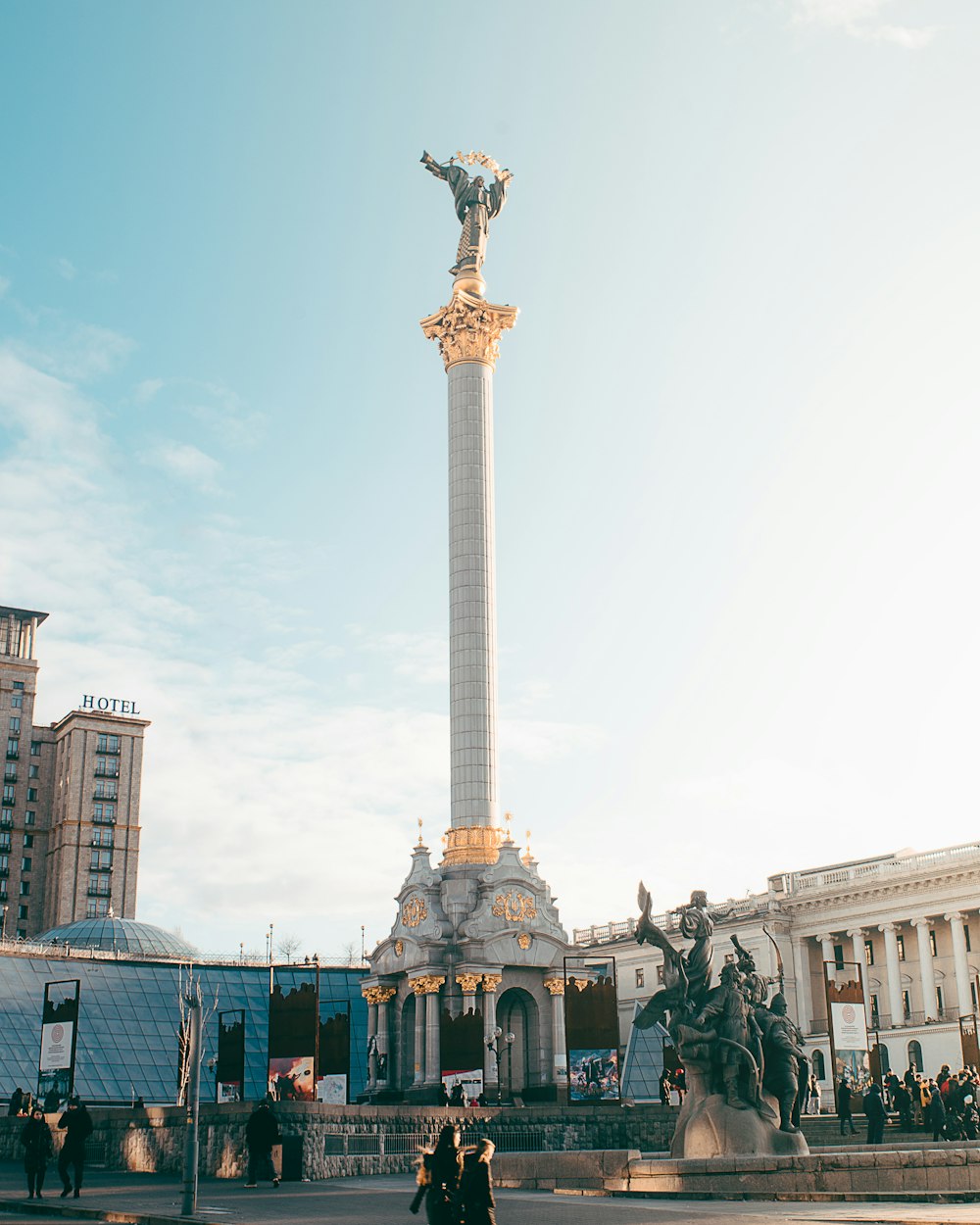 angel statue on pillar during daytime