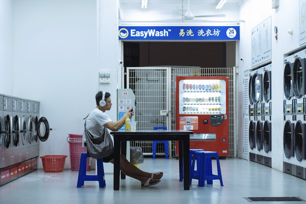 man sitting on chair in front of table