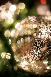 Close-up of a hand-painted glass ball with intricate dot painting details.