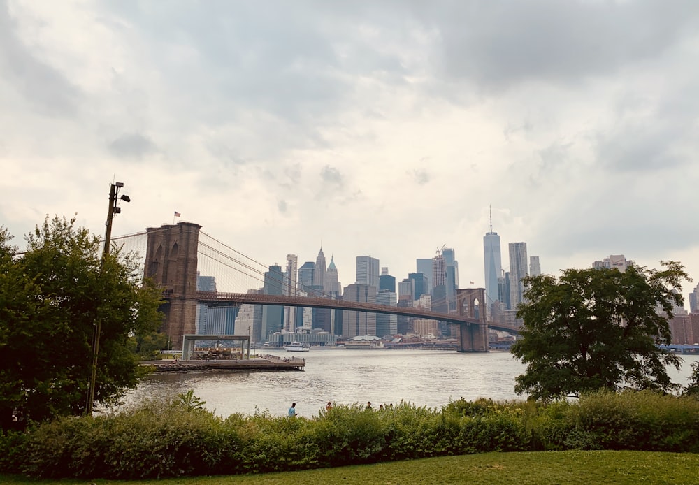 Brooklyn bridge and cityscape under white sky