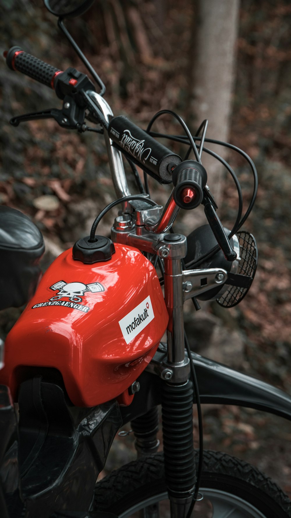 selective focus photography of parked red motorcycle