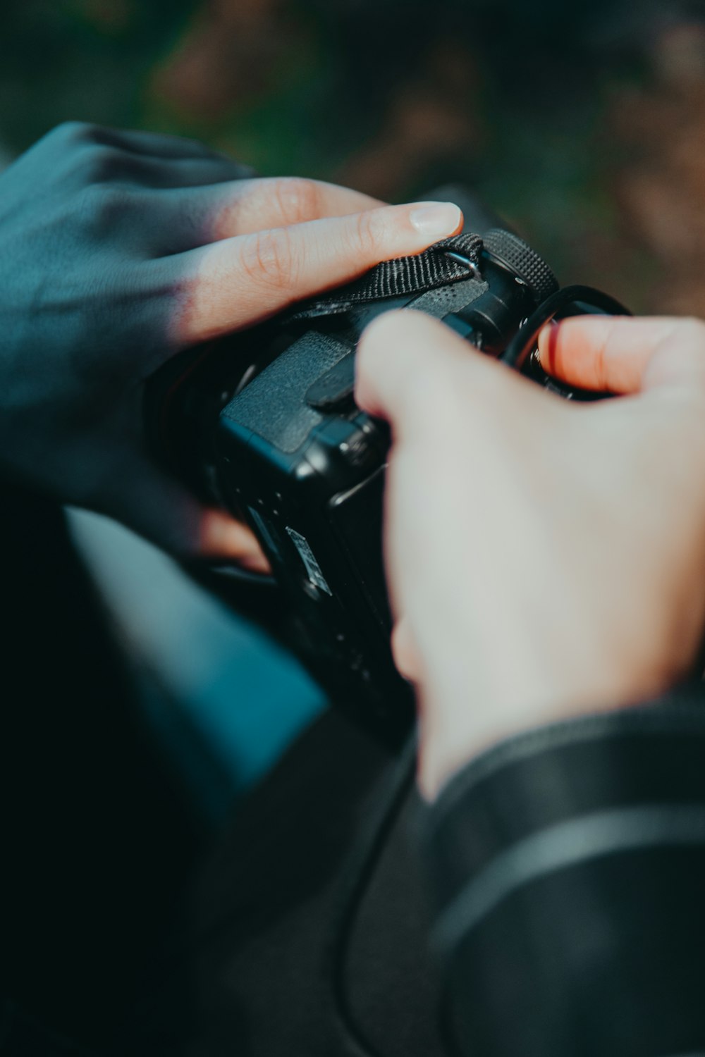 selective focus photography of person holding black camera