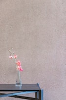 A delicate artificial flower arrangement brightening up a minimalist wooden table.