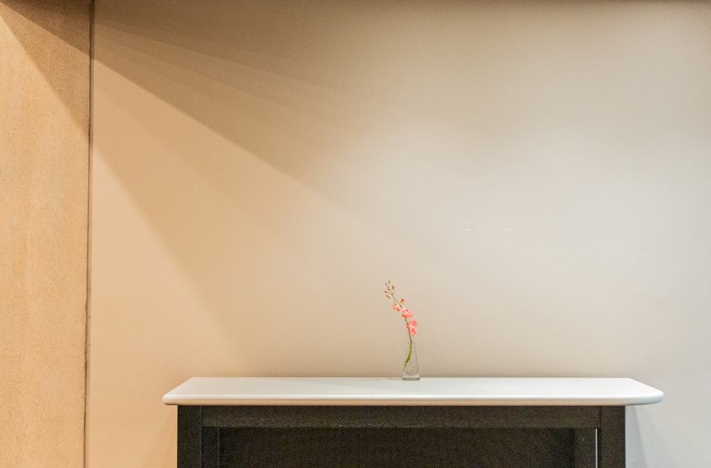 white wooden table with flowers and vase