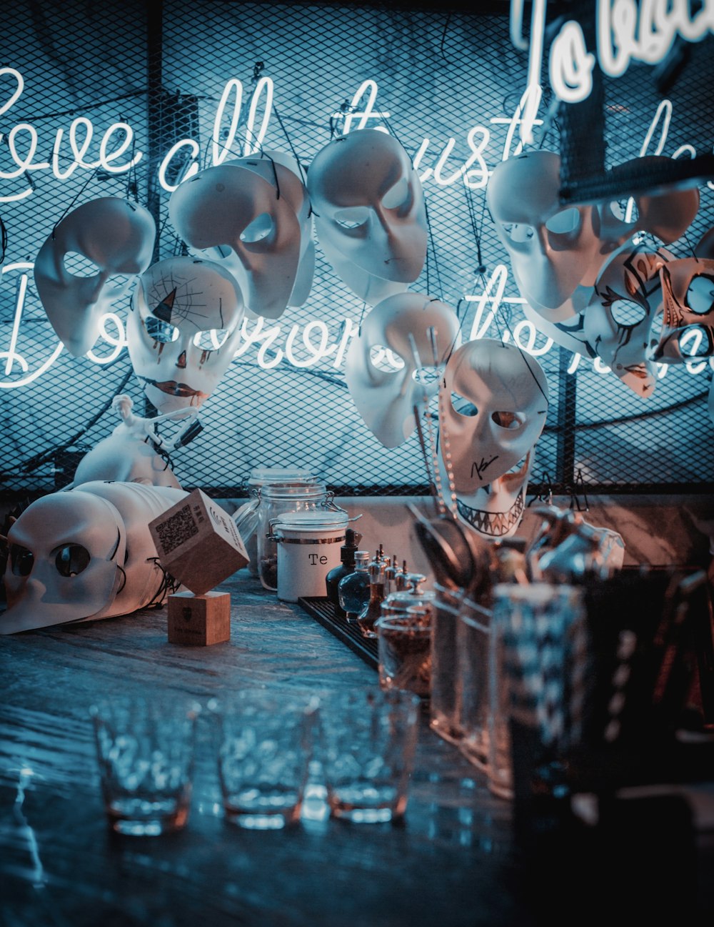 hanged skulls inside room with neon signs