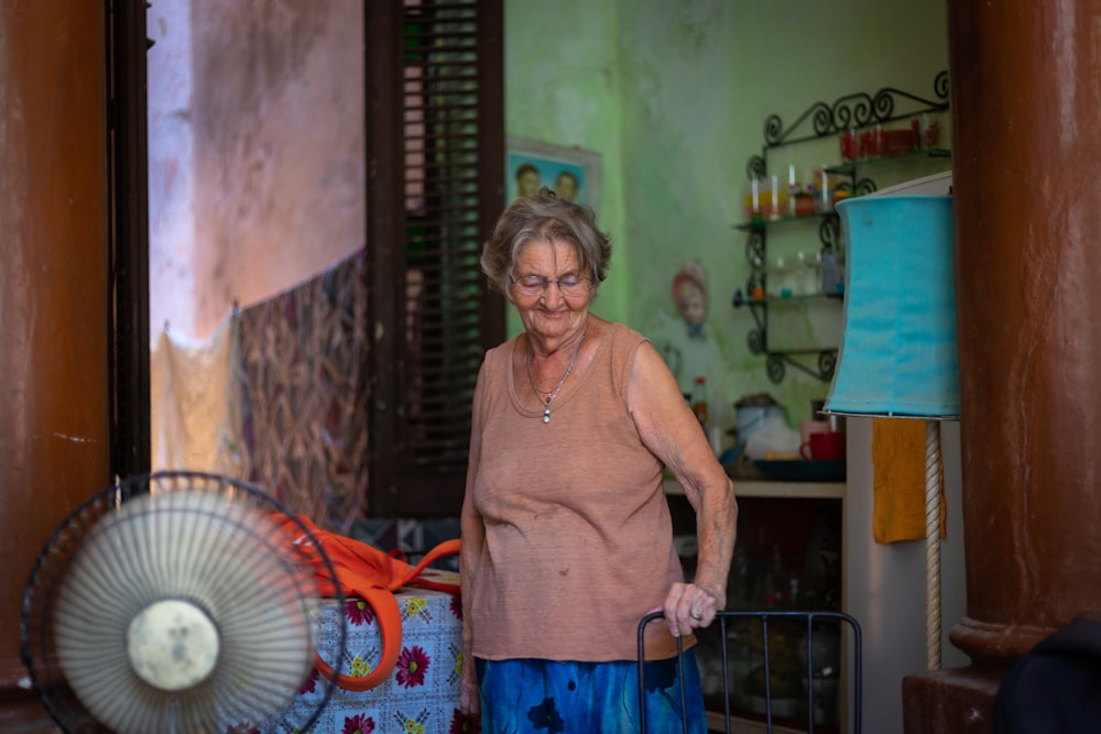 woman standing in front of turned-on fan