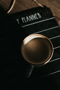 coffee mug on top of planner