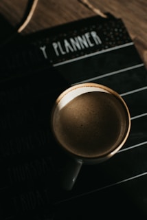 coffee mug on top of planner