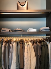 folded clothes above hanged clothes