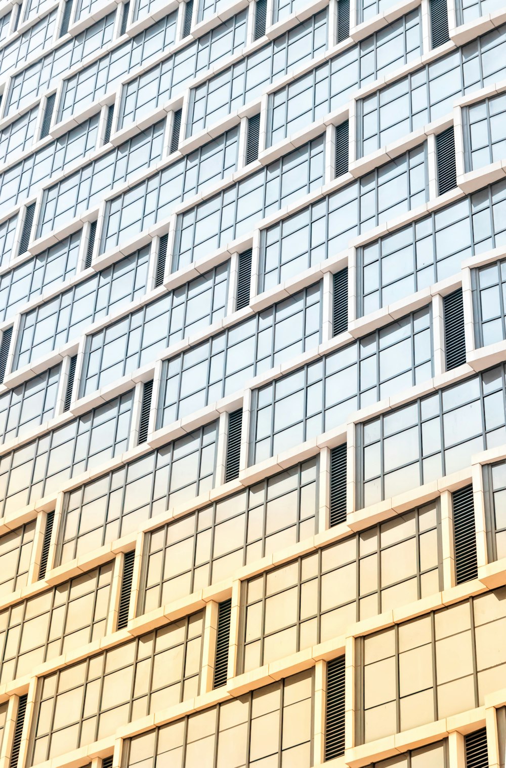 low-angle photography of curtain wall high-rise building