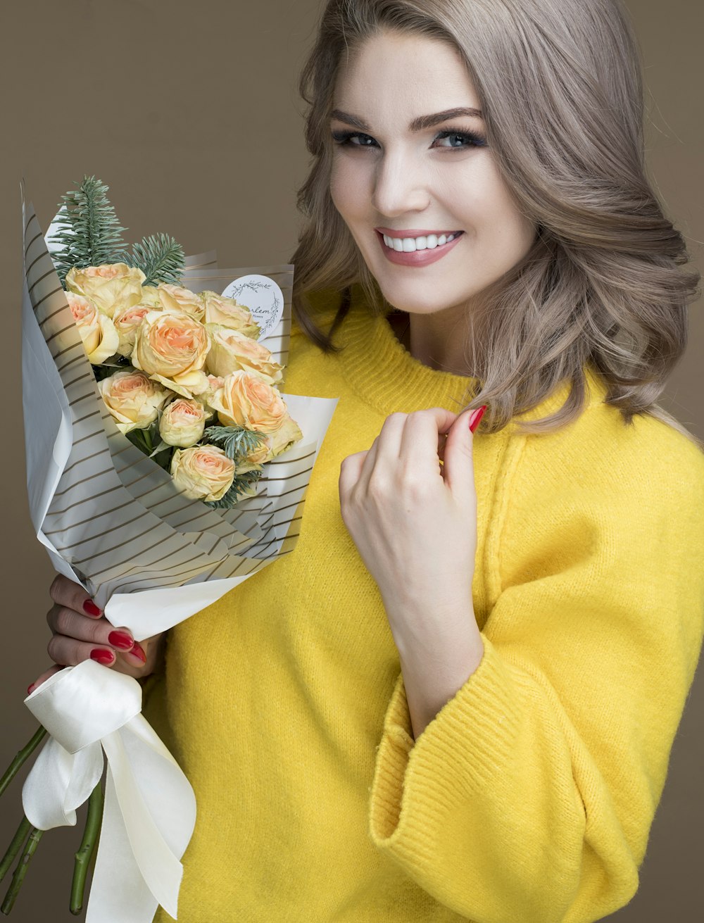 selective focus photography of smiling woman holding bouquet
