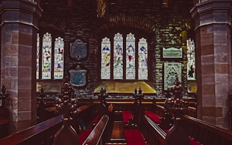 A peaceful church interior with stained glass windows.