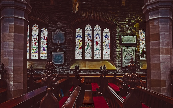 A peaceful church interior with stained glass windows.