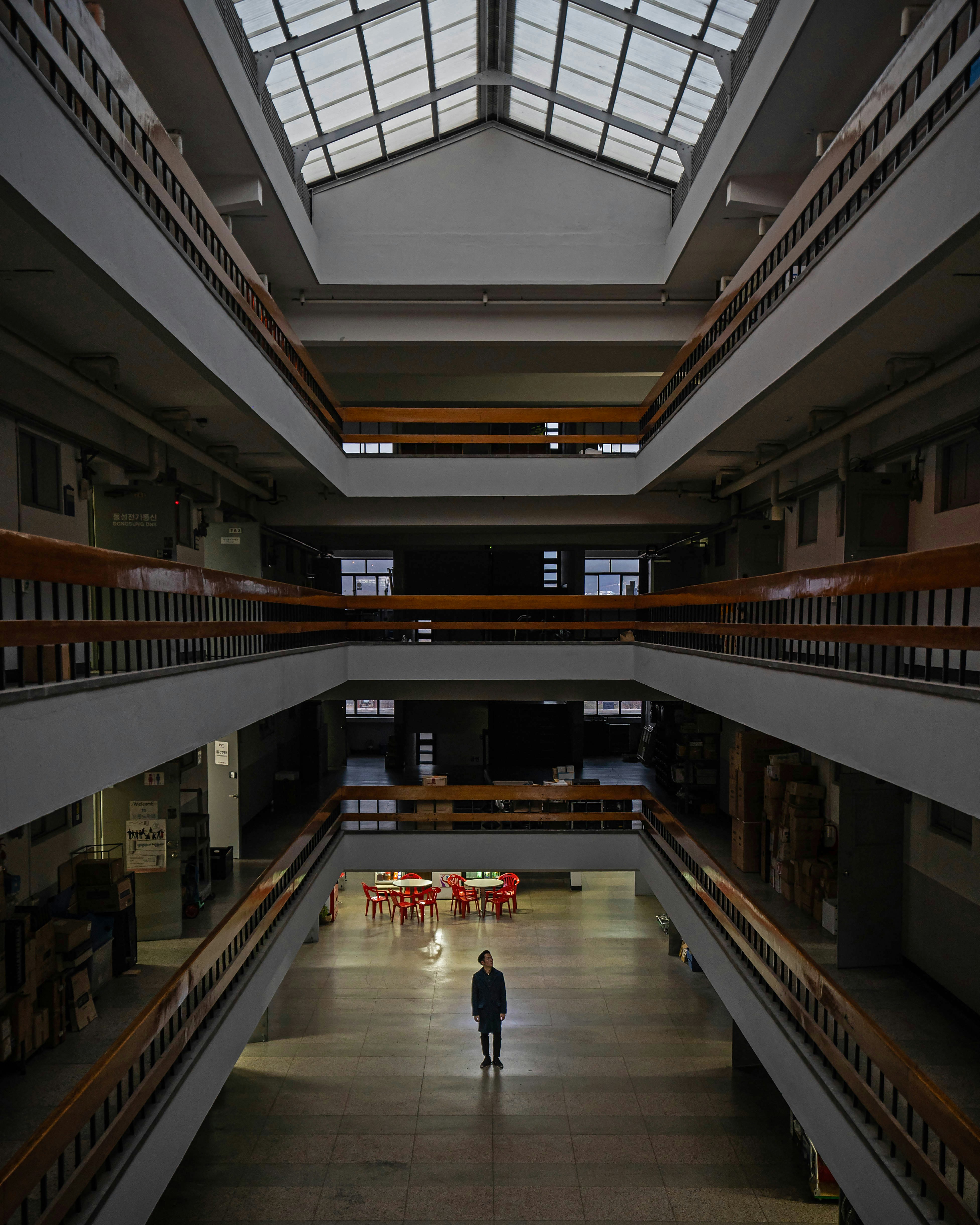 silhouette of person standing near red tables