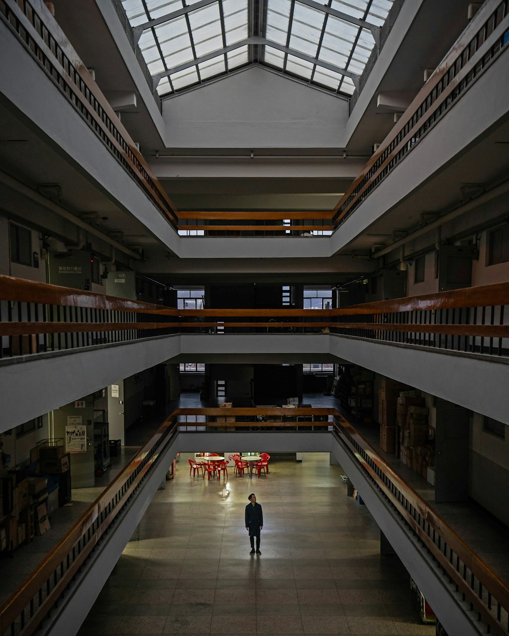 silhouette of person standing near red tables
