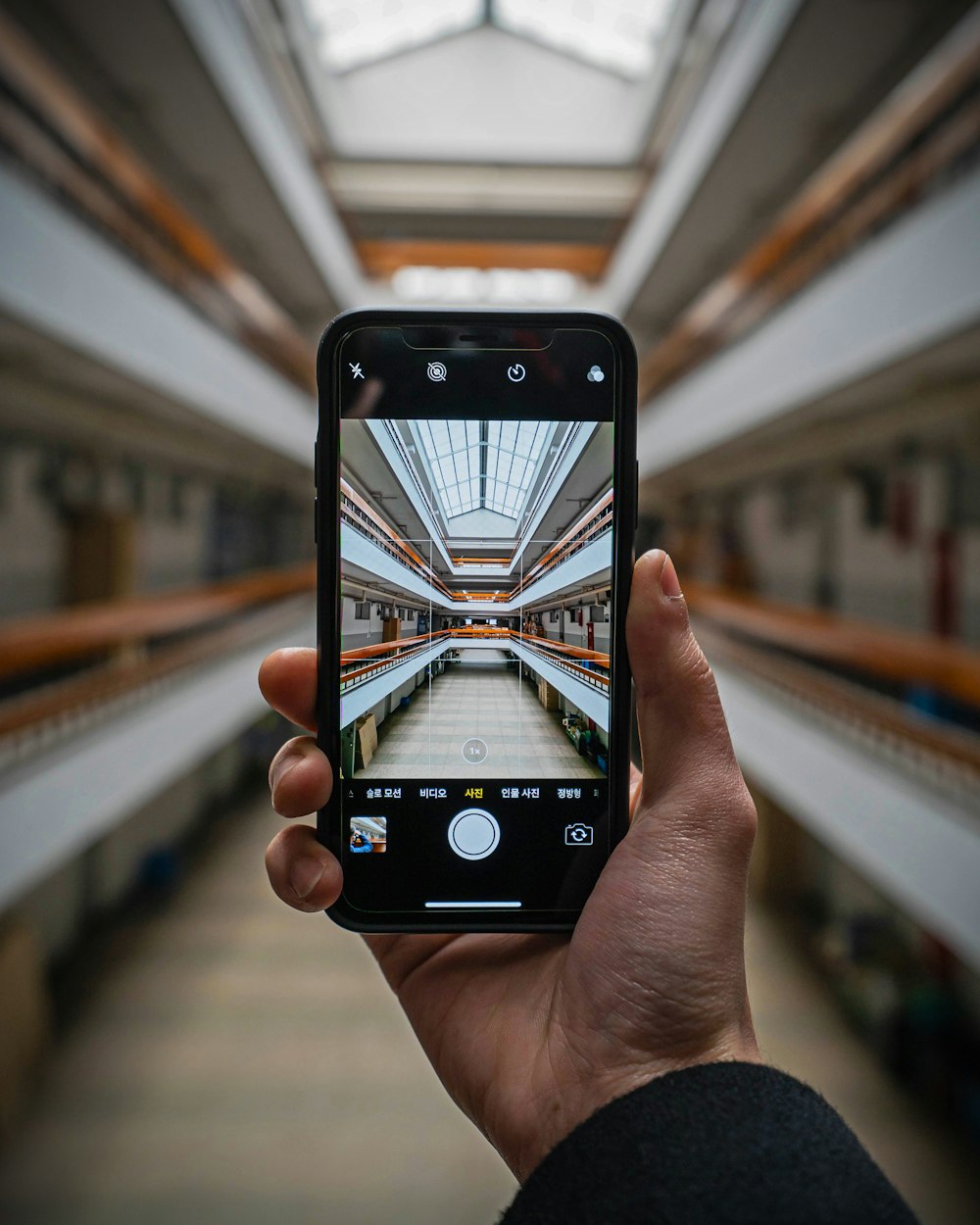 shallow focus photo of person taking photo using smartphone