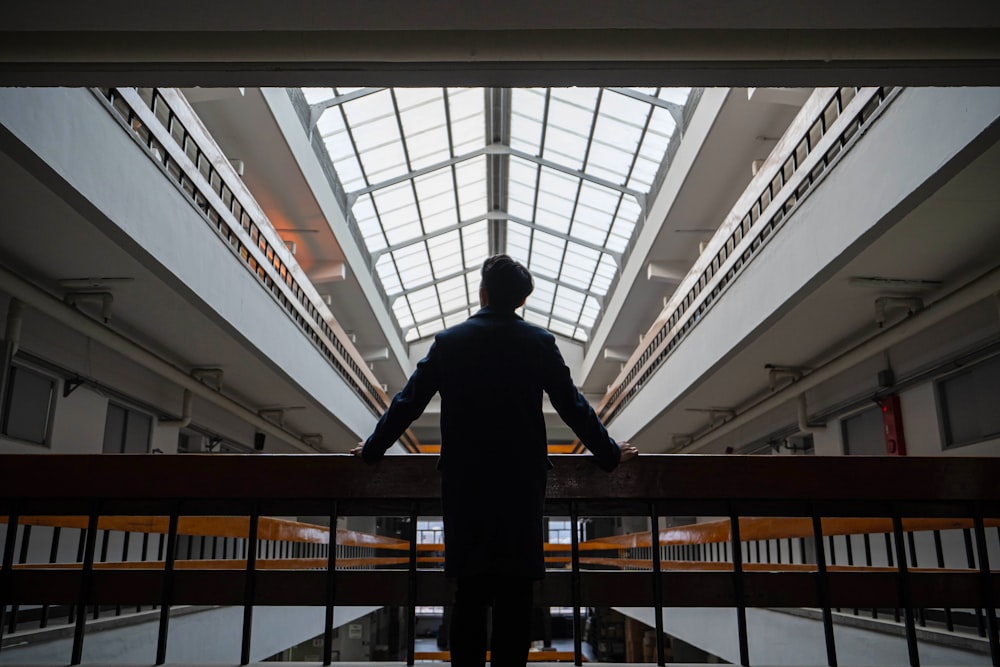 man standing in front of rail