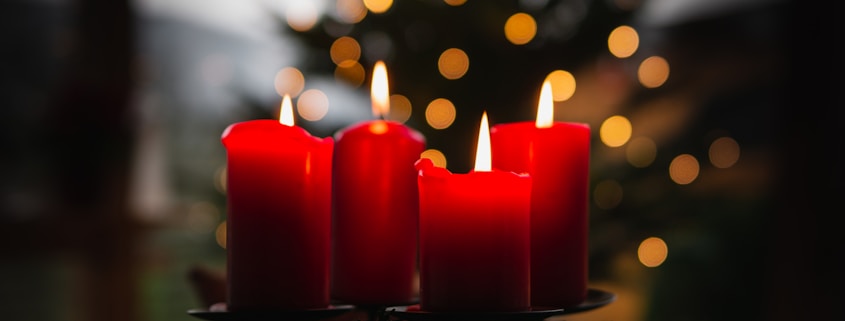 shallow focus photo of four red lighted candles