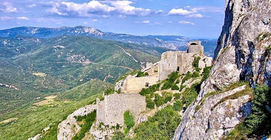 gray building on mountain during daytime in Puylaurens France