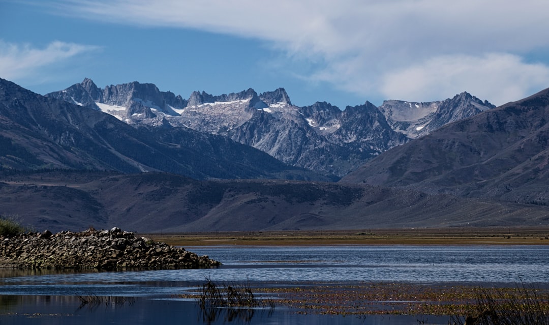 snow covered mountains under cloudy sky