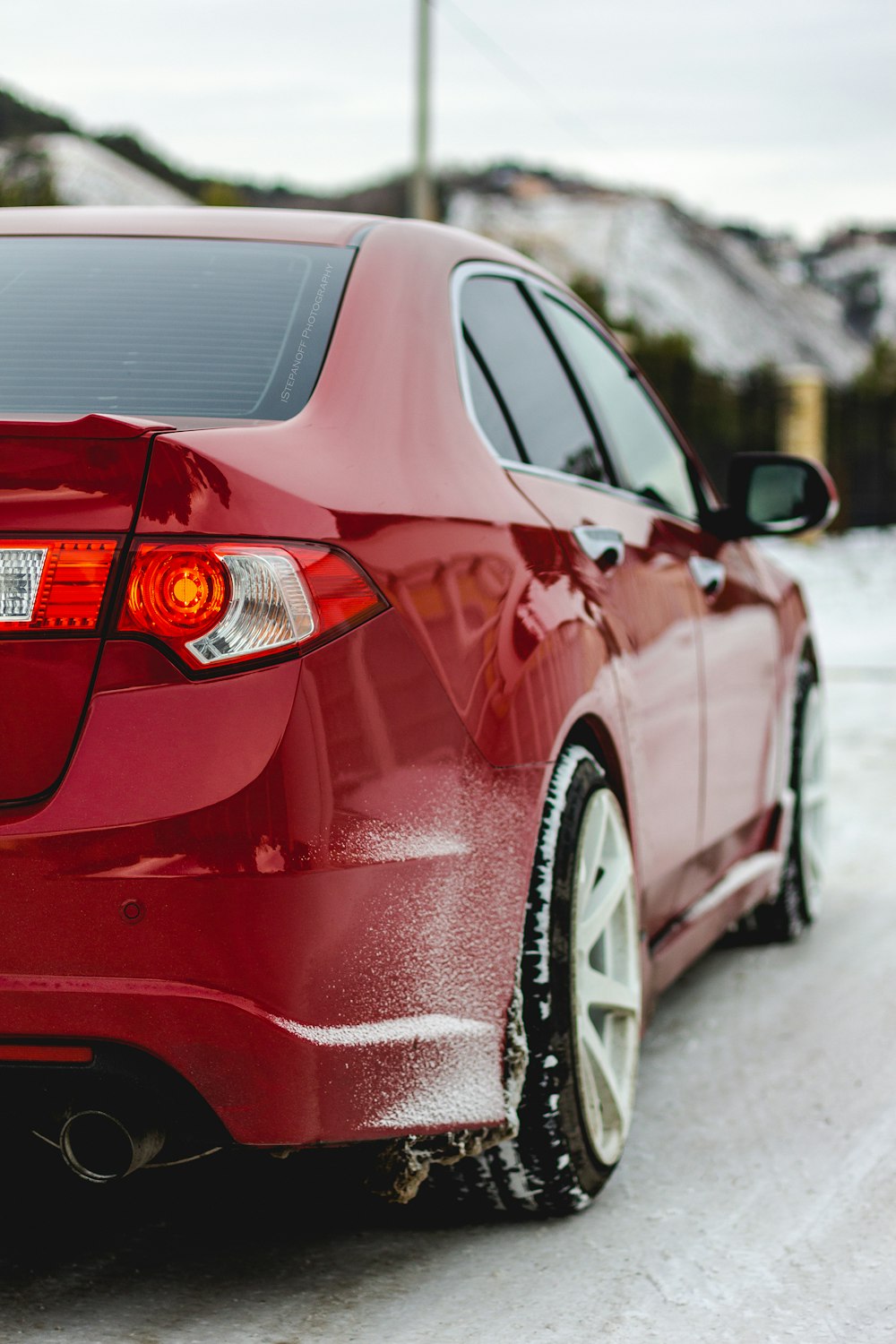 red sedan on snowy ground