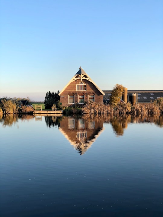 brown wooden house photograph in Amstelhoek Netherlands