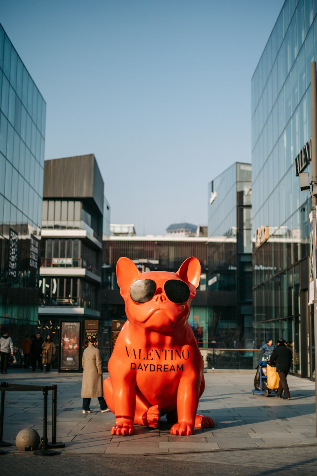 red dog statue beside glass building