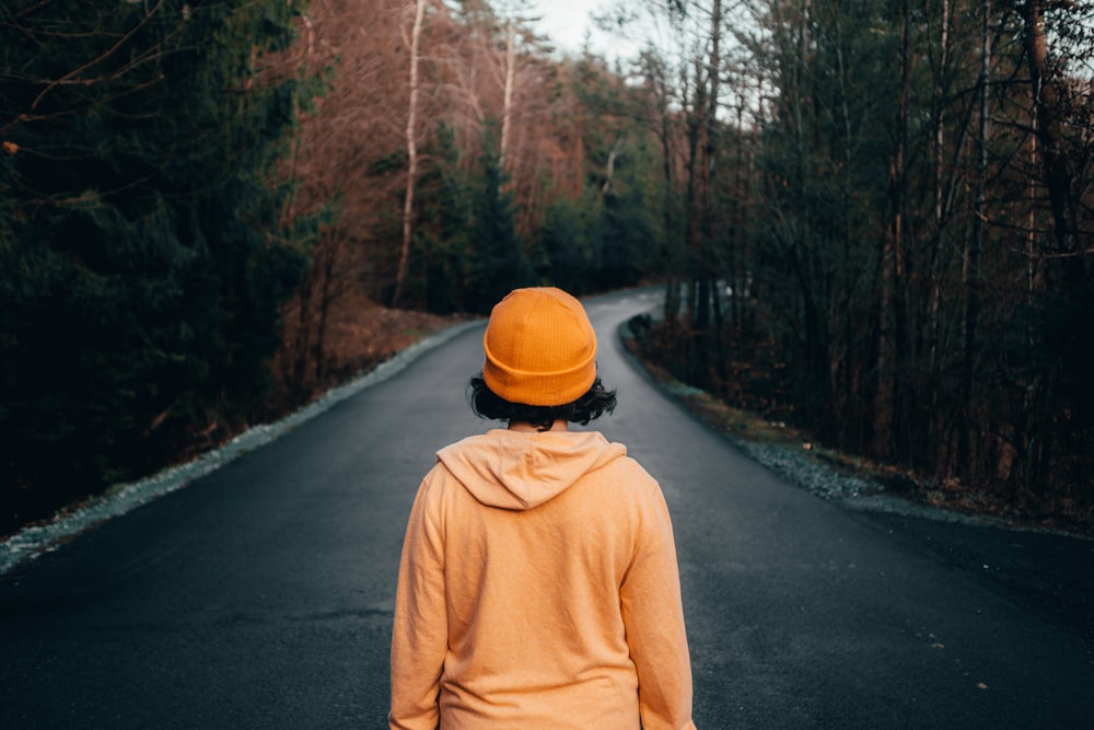 woman wearing yellow knit cap standing on the road
