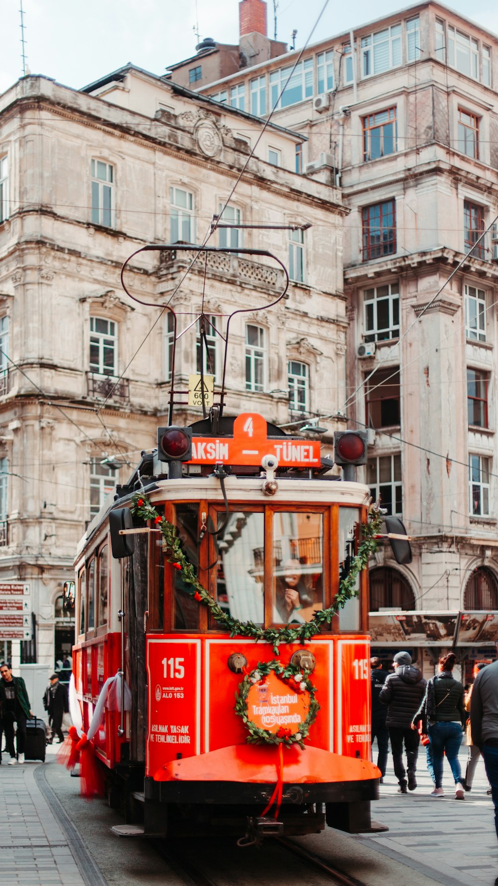 orange and white tram on railroad