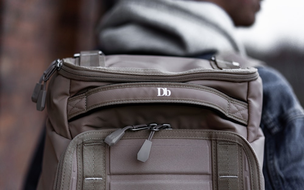 person wearing gray backpack during day