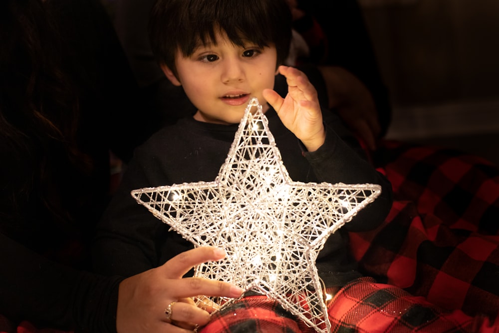 boy holding christmas star