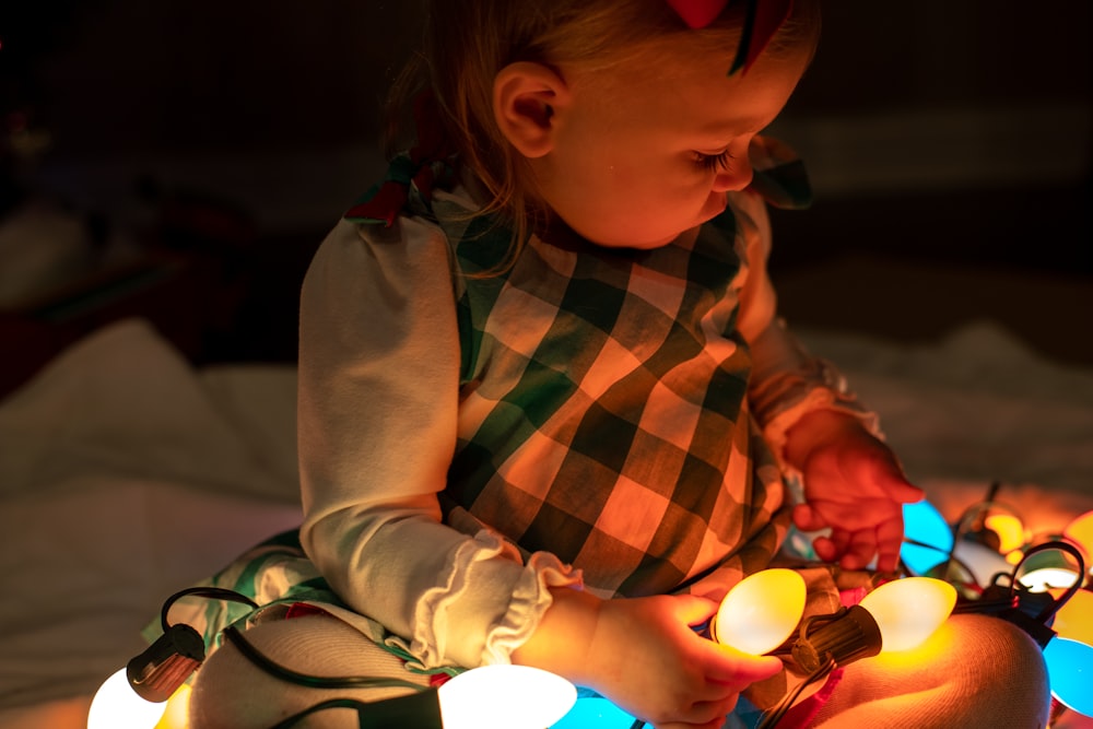 girl holding string lights