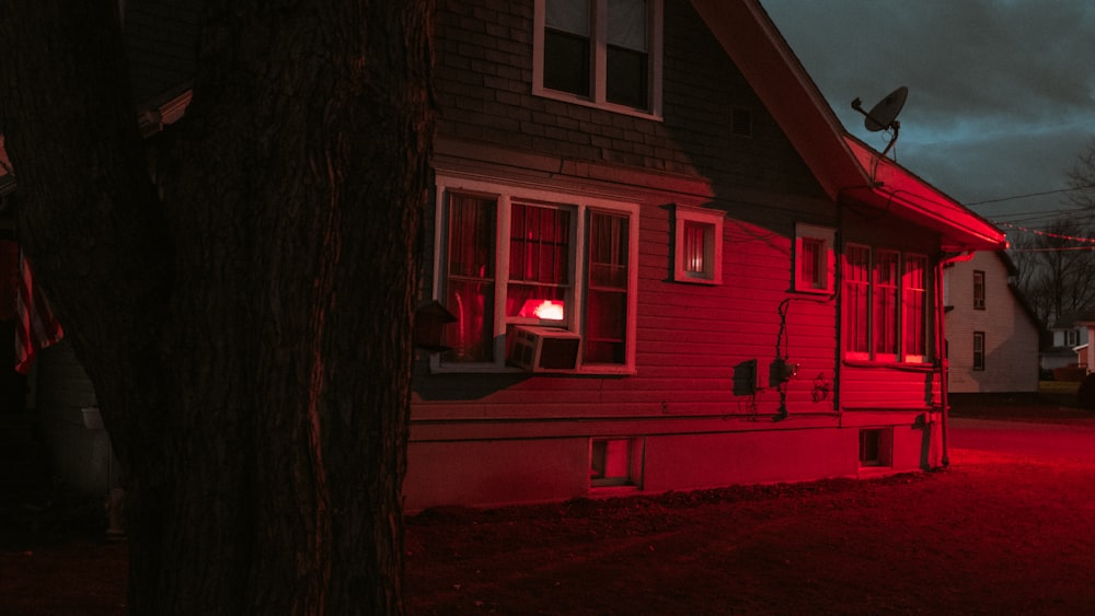 a red light shines on a house at night